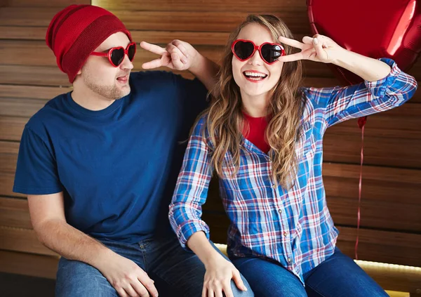 Couple in heart-shaped sunglasses — Stock Photo, Image
