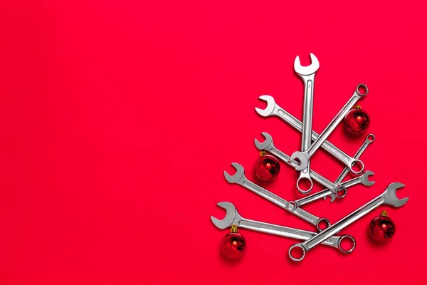 Christmas Tree Made Wrenches Decorated Balls Red Background New Year — Stock Photo, Image