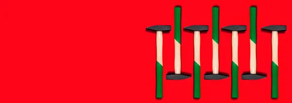 赤色の背景に隔離されたハンマーのパターン 建設ツールでバナーを買い物します 新年やクリスマスのお祝いの背景 釘を打つための基本的な家庭用器具の一つ 建築設計 — ストック写真