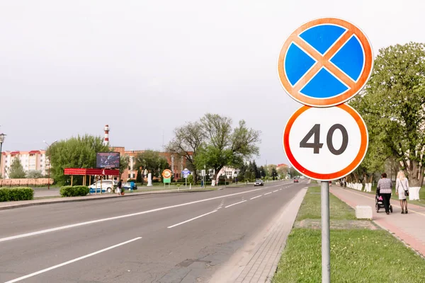 The sign of the maximum speed limit and sign prohibiting the stop on city background. Forty kilometers or miles per hour sign limitation sign. Driving school. Education course. Traffic laws. Street.