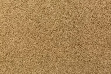 Kahverengi alçı dokusu örneği. Duvar, dekoratif çimento sıva ile kaplanmış. Dış bina dekorasyonu örneğiydi. Temiz üniformalı, kumlu bir geçmişi var. Pankart. Duvar kağıdı. Uzayı kopyala Desen.