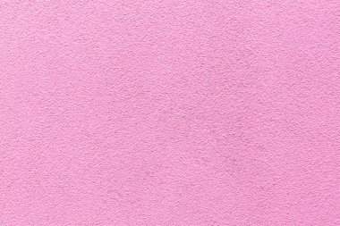 Pembe alçı dokusu örneği. Duvar, dekoratif çimento sıva ile kaplanmış. Dış bina dekorasyonu örneğiydi. Temiz üniformalı, kumlu bir geçmişi var. Pankart. Duvar kağıdı. Uzayı kopyala Desen.