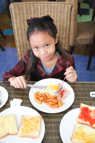 Girl eating breakfast — Stock Photo, Image