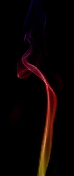 Smoke color yellow, red and blue isolated on black background.