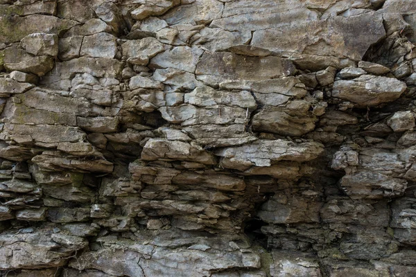 Pared de piedra de roca con grietas — Foto de Stock