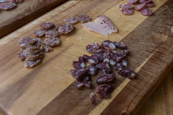 Slices of salami on a cutting board — Stock Photo, Image