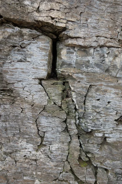 Stone wall of rock with cracks — Stock Photo, Image