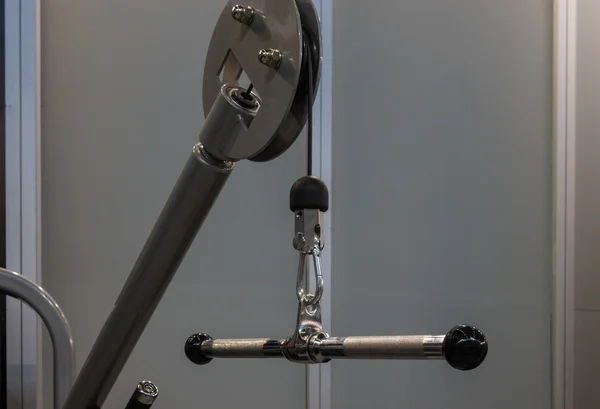 handle of weight machine with carbine in fitness center