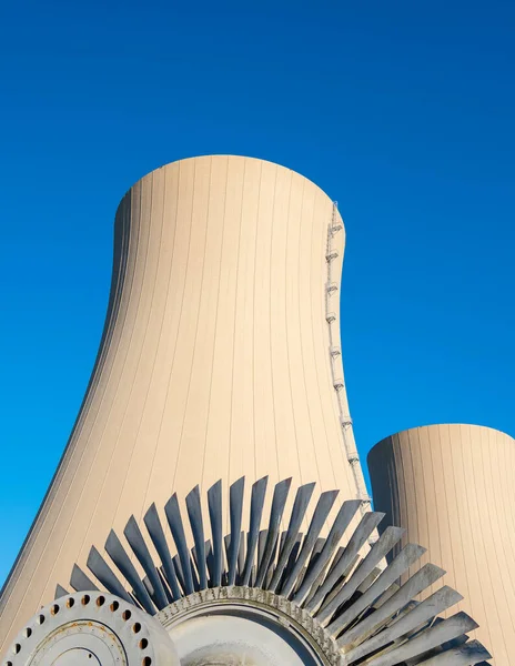 Steam turbine against nuclear power plant and sky