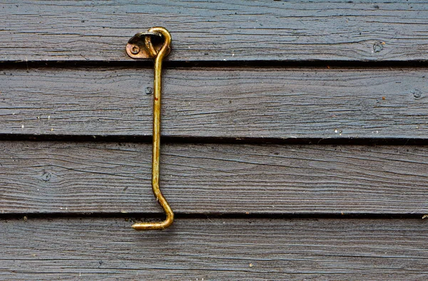 Gancio porta in olio su parete di legno — Foto Stock