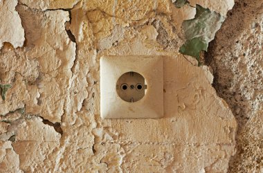 Old electrical outlet on decrepit wall clipart
