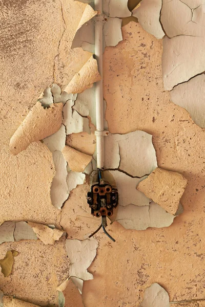 Vieille prise électrique cassée sur un mur décrépit — Photo