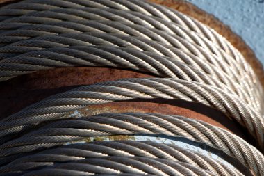 Steel cable on the reel in the sunshine clipart