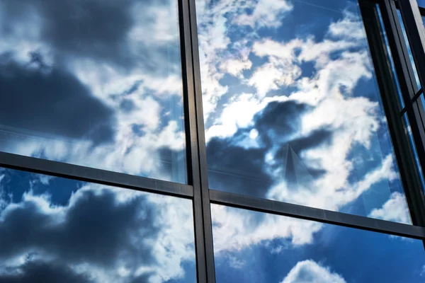 Weerspiegeling van de lucht en de wolken in de ramen van gebouw — Stockfoto