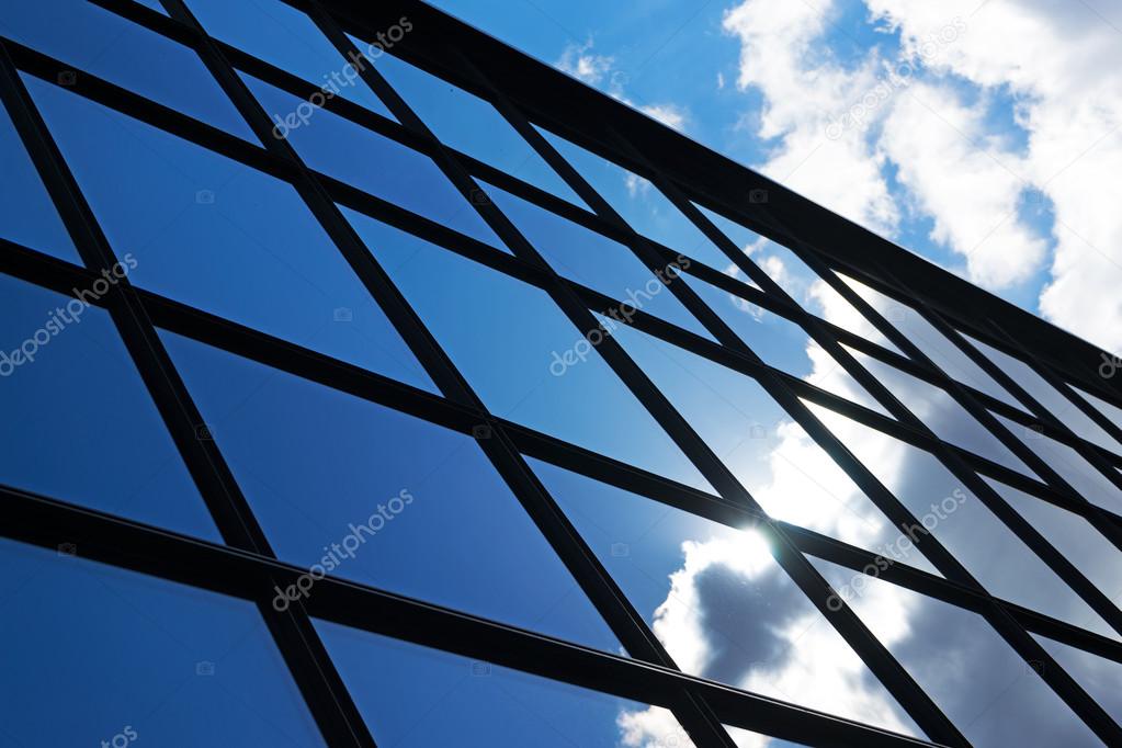 Reflection of the sky and clouds in the windows of  building