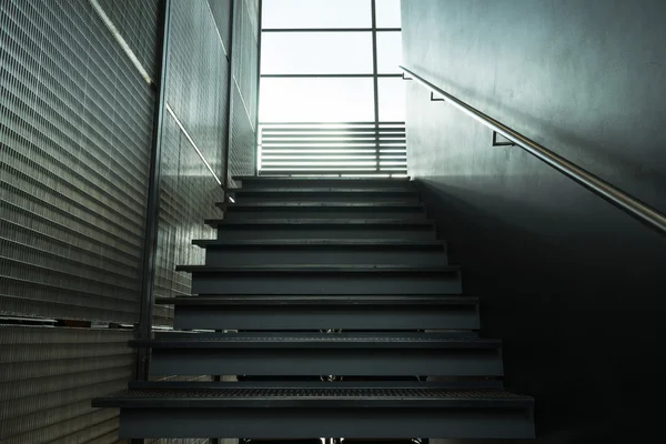 Metal stairs inside building leading window — Stock Photo, Image