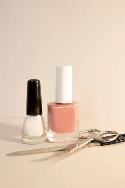Manicure, varnish and nail scissors on a light background
