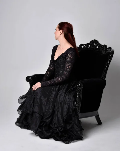 Full Length Portrait Woman Wearing Black Gothic Dress Sitting Ornate — Stock Photo, Image