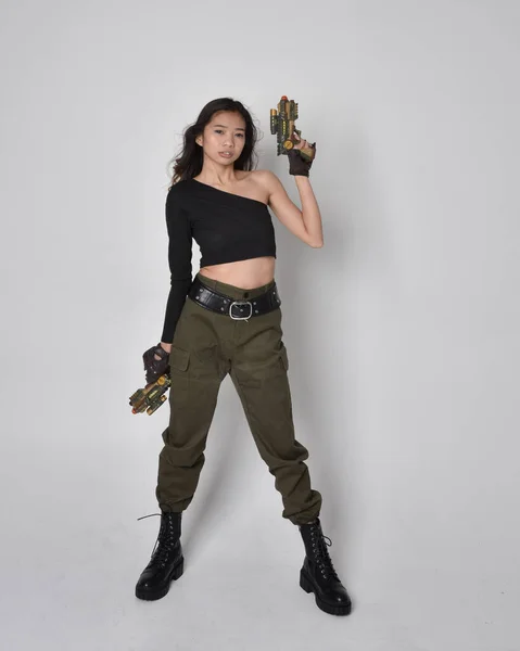 Image of A Young Indian Man Holding Gun And Posing On an Isolated White  Background-PF109869-Picxy