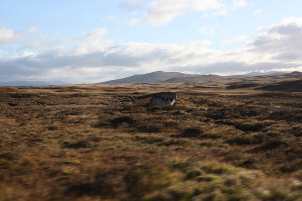 Highland valleys of Glen Coe in Scotland, showcasing rugged mountains, deep glens, and expansive views across a dramatic ancient European  landscape