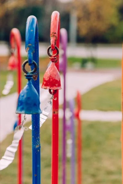 multi-colored wind chimes with metal plates that create a beautiful sound from the wind. selective focus.