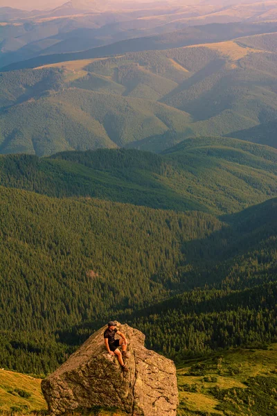 The top of Mount Pip Ivan, a tourist admires the scenery from the top, a hike in the Ukrainian Carpathians, fascinating epic photos.
