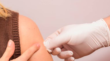 The laboratory assistant injects an antiviral into the patient's hand, carrying out the procedure close-up. new