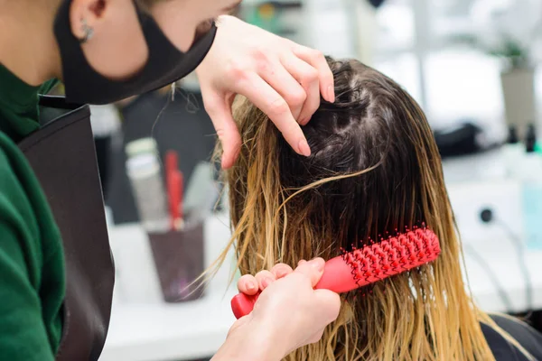 Combing wet hair, clean and washed head, preparation for a haircut. new