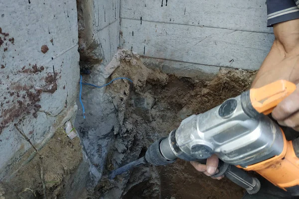 jackhammer in action, pneumatic construction tool, drilling a hole in the concrete wall.new