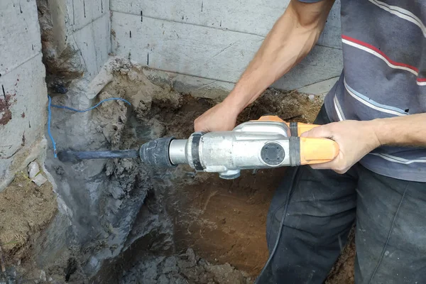 jackhammer in action, pneumatic construction tool, drilling a hole in the concrete wall.new