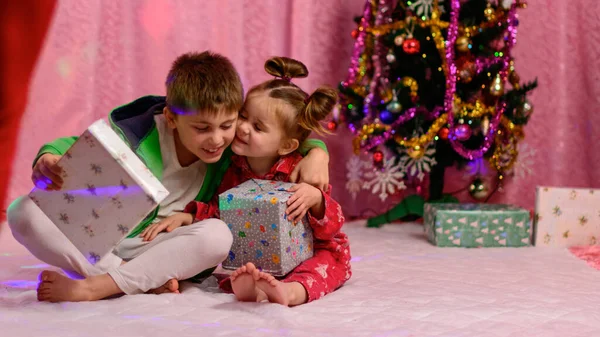 Irmão Uma Irmã Estão Olhando Presentes Perto Árvore Natal Véspera — Fotografia de Stock