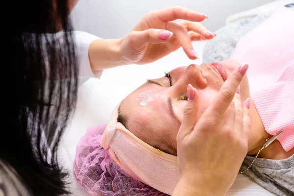 Facial massage at the beautician at the reception, visiting a beauty salon, a sense of relaxation. new