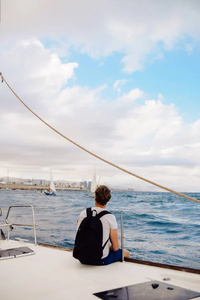 Guy Traveler Backpack Sits Sailing Yacht Enjoys Views Man Yacht — Stock Photo, Image