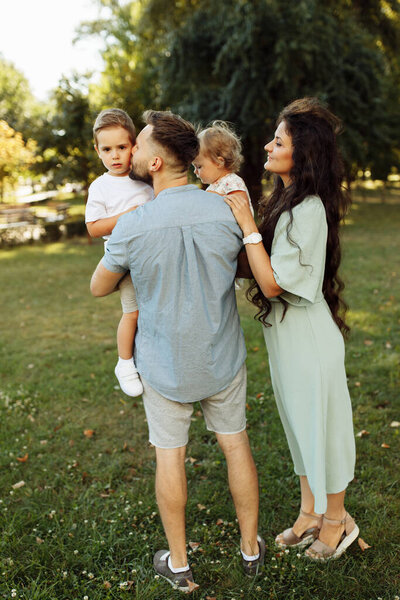 Happy young family with children relaxing  in the park