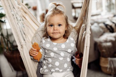 Küçük kız evde salıncakta dinleniyor. 