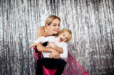 Mutlu genç anne ve oğlu alışveriş arabasında eğleniyorlar. 