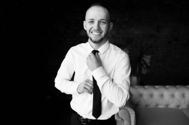 Genç yakışıklı damat içeride poz veriyor.