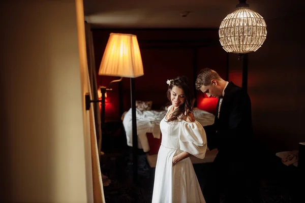 Happy Young Groom Helping Bride Put Dress — Stock Photo, Image