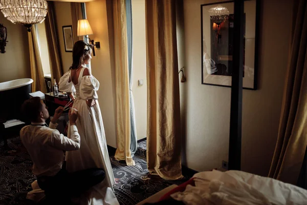 Happy Young Groom Helping Bride Put Dress — Stock Photo, Image