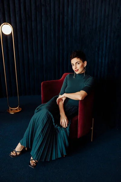 portrait of  beautiful young woman   on chair  in studio