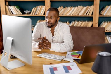 Masada oturan Afro-Amerikan bir gencin portresi.