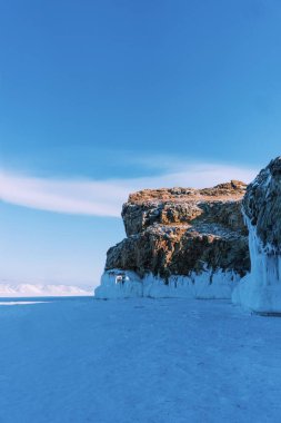 Baykal Gölü, kış günü. Olkhon Adası 'ndaki yüksek uçurumlar. Büyük buz blokları dağların eteklerini kaplıyor..