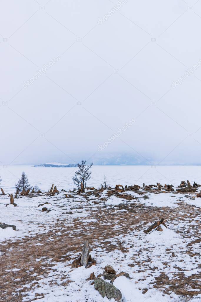 Pyramids of stones in winter on Lake Baikal.