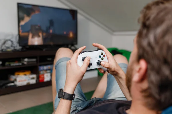 a man playing on a game console