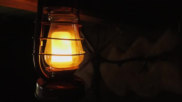 Antique lamp imitating candle fire inside — Stock Video
