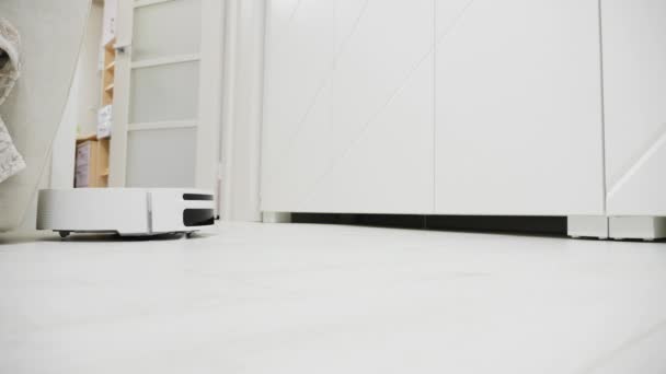 Witte robotstofzuiger in de woonkamer die stof reinigt — Stockvideo