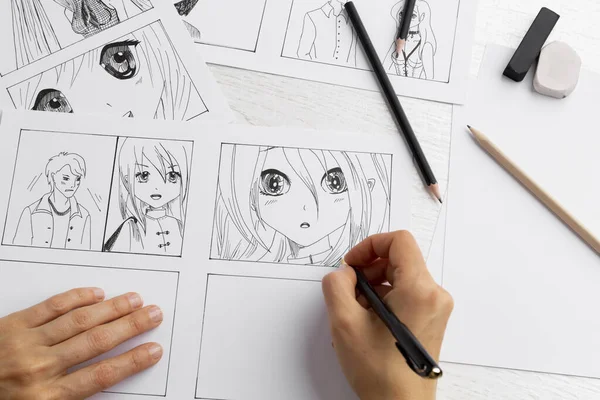 The artist draws anime comics on paper. Storyboard for the cartoon. The illustrator creates sketches for the book.