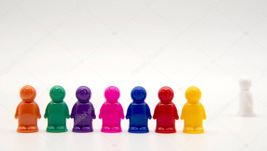 Small plastic multicolored men on a white background.