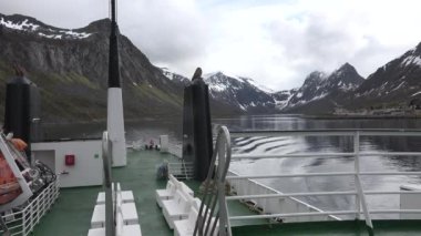 Cruise by ship along the coast of Norway to the Lofoten Islands.