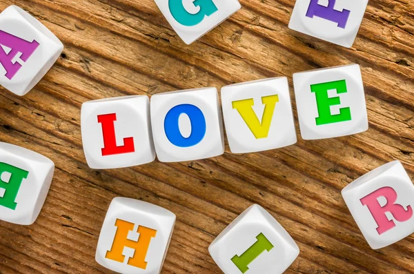Buchstabenwürfel auf einem hölzernen Hintergrund - Liebe — Stockfoto